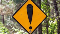 Orange diamond sign featuring a black exclamation point